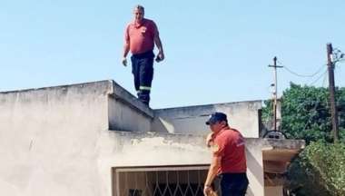 Bomberos inspeccionan la vivienda atacada.